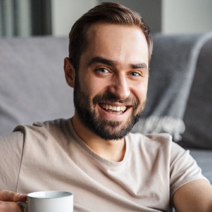 httpselements.envato.comattractive smart young man sitting on a floor in t 22hxgdx.jpg